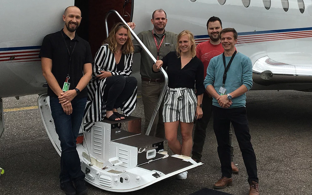 FLYINGGROUP planning team in front of a private jet